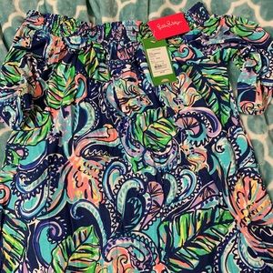 Lilly Pulitzer hanging with grinds off shoulder